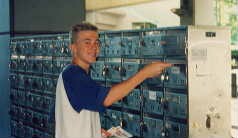 A summer worker stuffing mailboxes